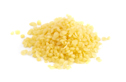 A Pile of Natural Yellow Beeswax Pearls on a Wax Background